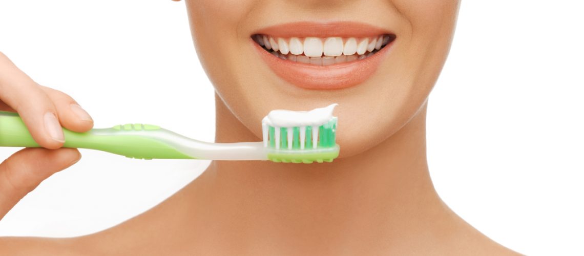 beauty and dental health concept - beautiful woman with green toothbrush